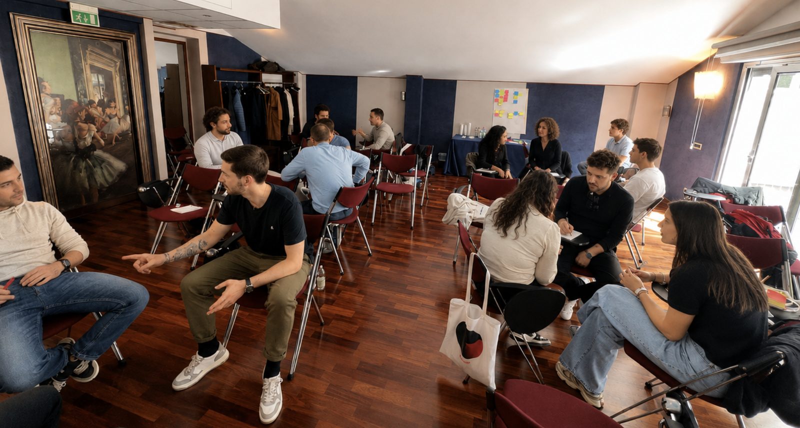 Gruppi di lavoro in sessione, disposti in cerchio in una sala